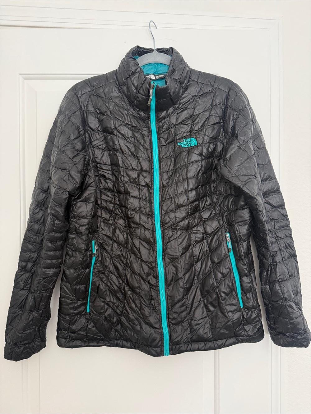 The North Face Women's Black Puffer Jacket with Teal Trim